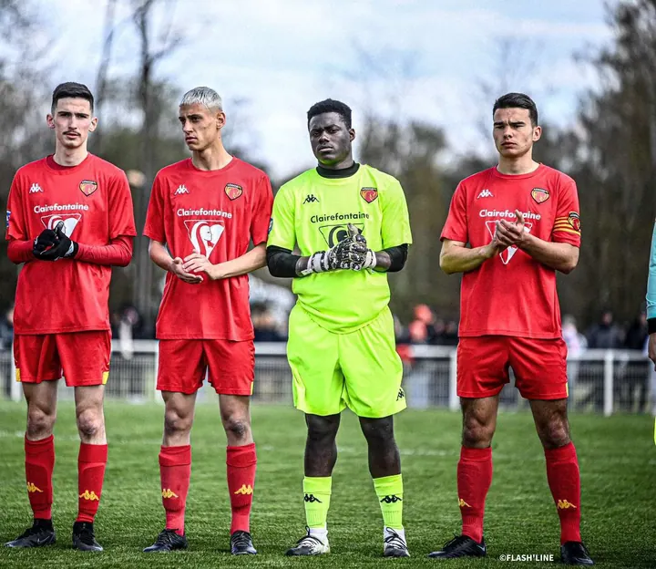 Four Le Mans FC players lined up on the pitch before a match.